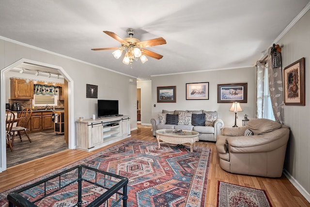 living room featuring hardwood / wood-style floors and crown molding