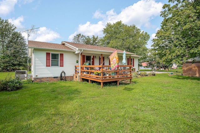 rear view of property featuring a lawn