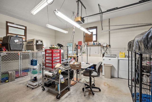 garage featuring washing machine and clothes dryer and a garage door opener