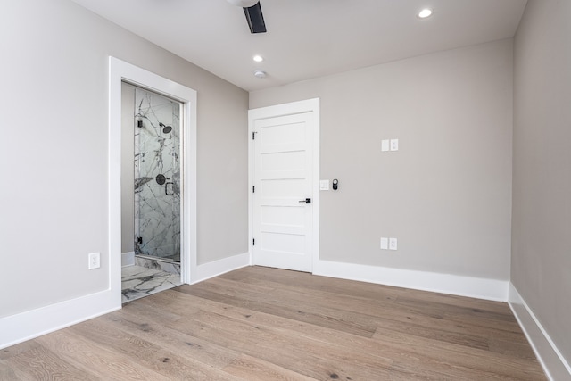 empty room with light wood-type flooring and ceiling fan