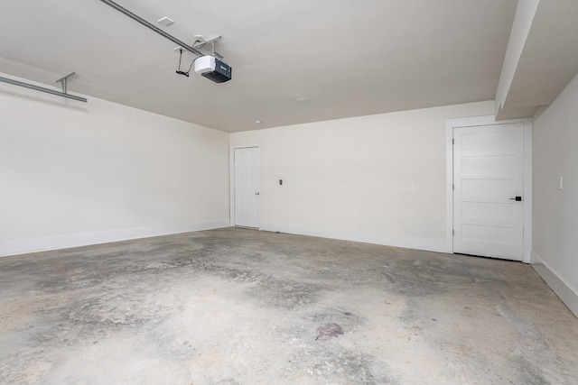 garage with baseboards and a garage door opener