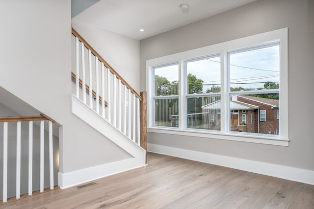 staircase with light hardwood / wood-style flooring