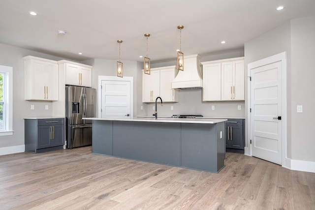 kitchen featuring gray cabinets, light countertops, stainless steel refrigerator with ice dispenser, and white cabinets