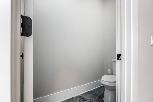 bathroom featuring tile patterned flooring and toilet