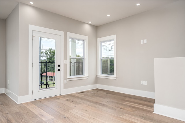 doorway with light hardwood / wood-style floors and plenty of natural light