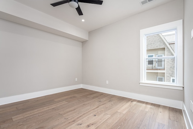 empty room with light hardwood / wood-style floors and ceiling fan