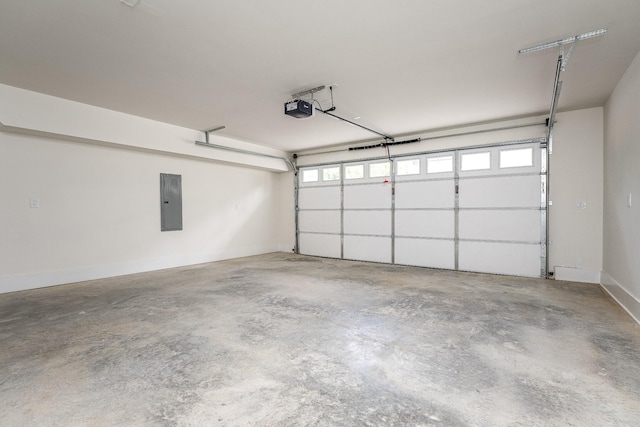 garage featuring a garage door opener, electric panel, and baseboards