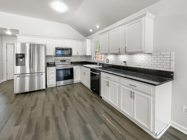 kitchen with vaulted ceiling, stainless steel appliances, sink, and white cabinets