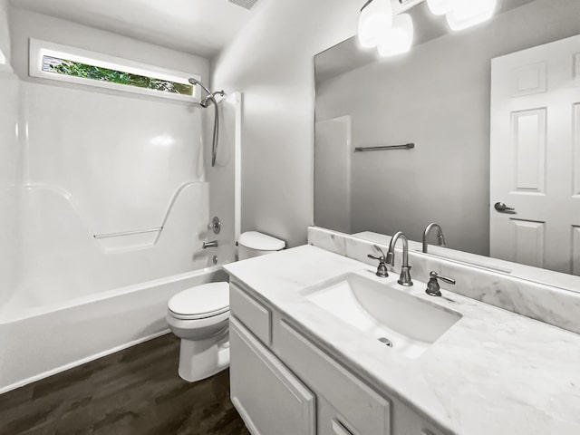 full bathroom featuring shower / tub combination, hardwood / wood-style floors, vanity, and toilet