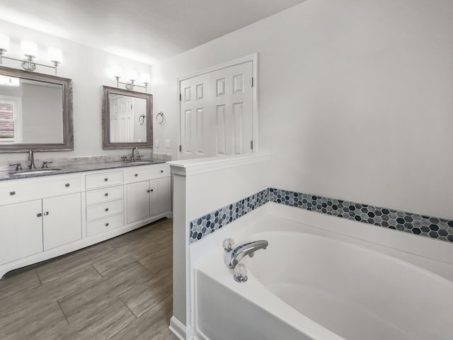 bathroom with vanity and a bathtub