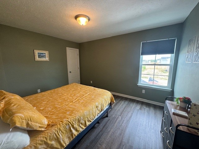 bedroom with hardwood / wood-style flooring and a textured ceiling