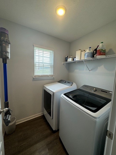 laundry area featuring independent washer and dryer, dark hardwood / wood-style floors, and a textured ceiling