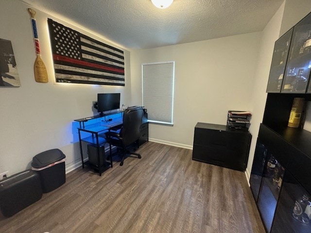 home office featuring dark hardwood / wood-style flooring and a textured ceiling