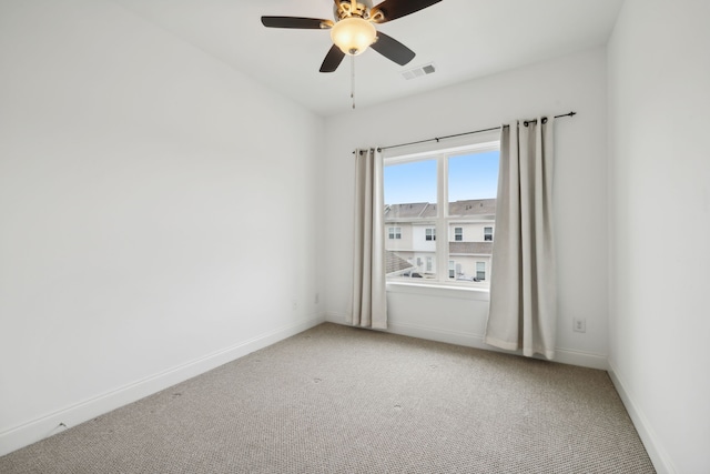 unfurnished room with ceiling fan and carpet flooring