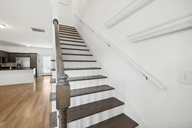 stairs featuring light wood-type flooring