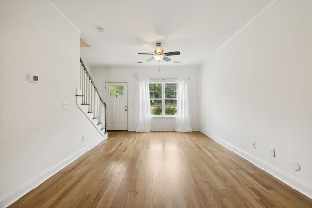 unfurnished room with light hardwood / wood-style flooring, ornamental molding, and ceiling fan