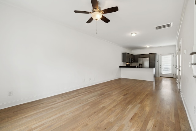 unfurnished living room with ceiling fan, light hardwood / wood-style floors, and crown molding