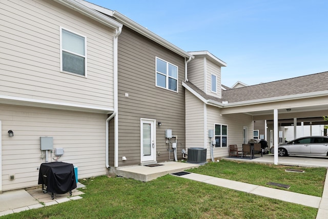 rear view of property featuring a patio area, a yard, and central air condition unit