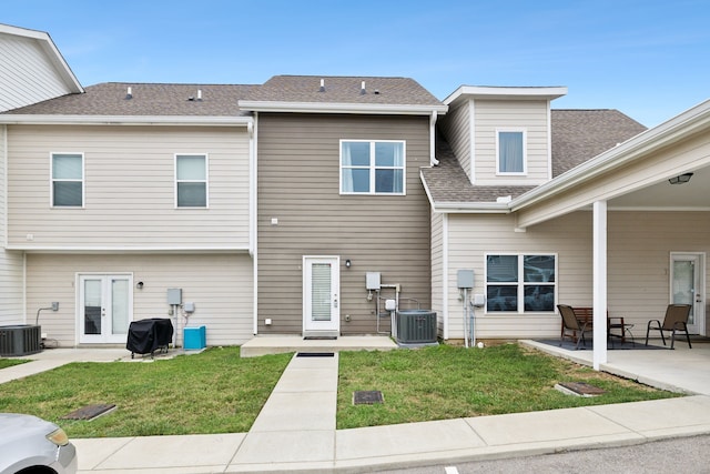 exterior space featuring central AC, a lawn, and a patio