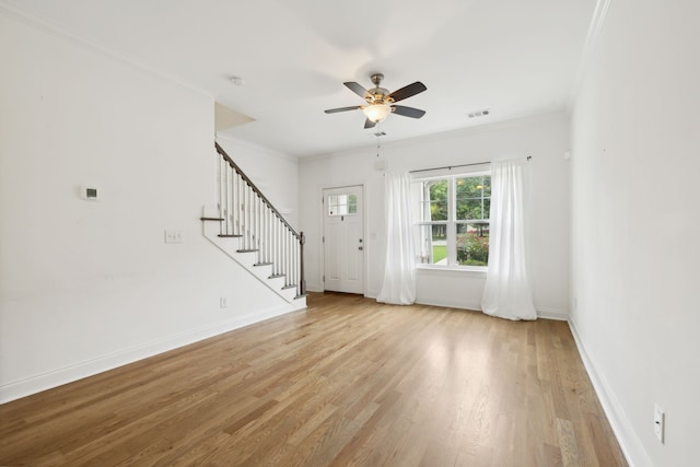 interior space featuring ceiling fan, ornamental molding, and light hardwood / wood-style floors