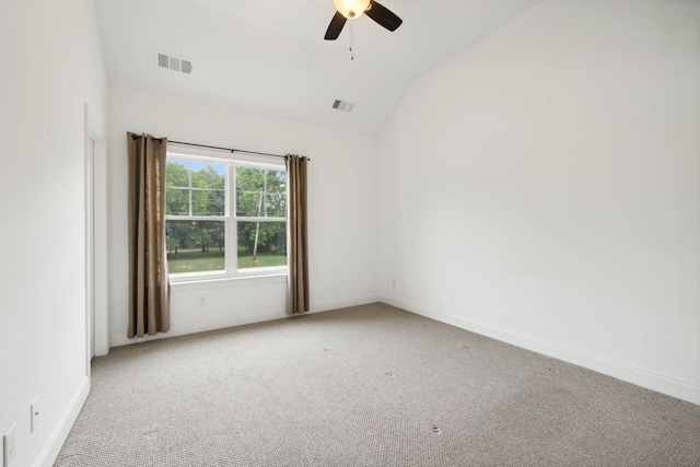 carpeted empty room featuring ceiling fan and vaulted ceiling