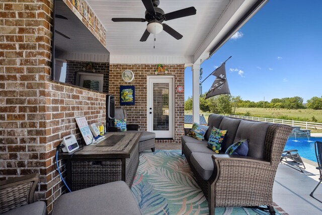 view of patio featuring ceiling fan, outdoor lounge area, and pool water feature