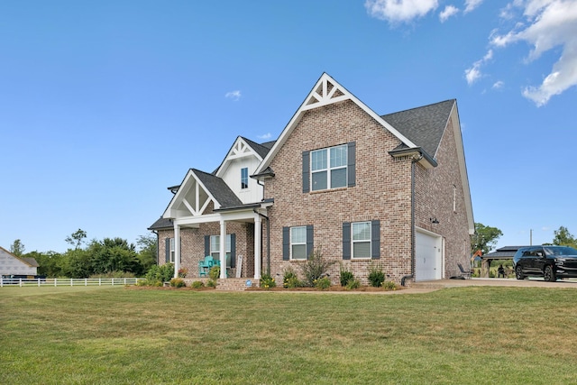 craftsman house featuring brick siding, driveway, and a front lawn