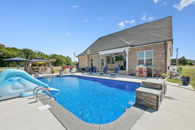 view of pool featuring a gazebo, a patio, and a water slide