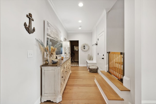 hallway featuring light hardwood / wood-style floors and ornamental molding