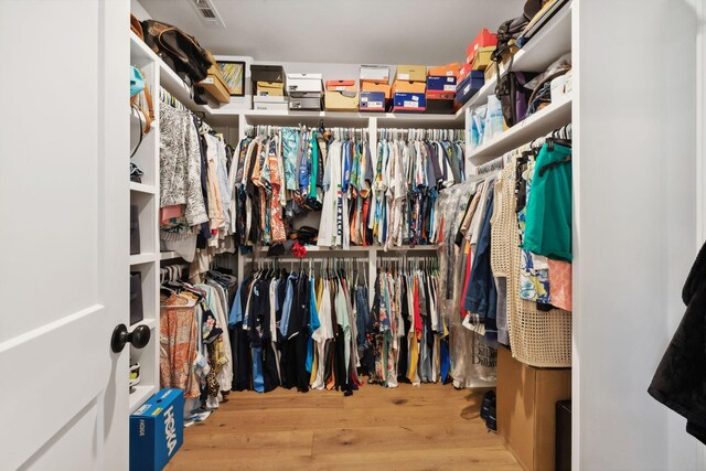 spacious closet with light hardwood / wood-style flooring