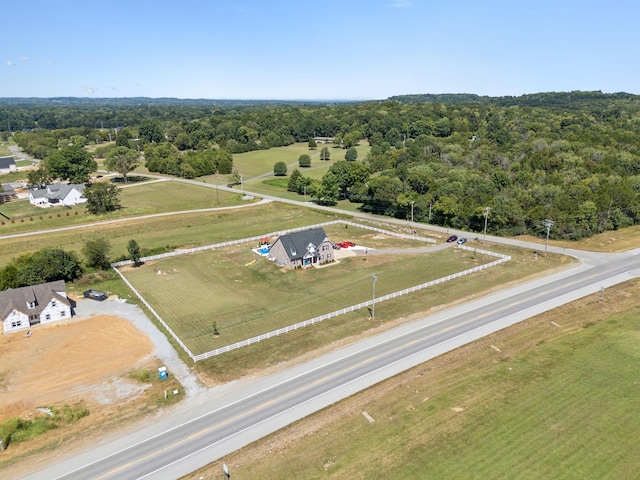 birds eye view of property with a forest view and a rural view