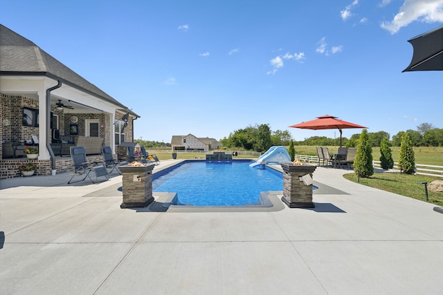 view of pool with ceiling fan and a patio area