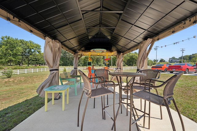 view of patio / terrace with fence and a gazebo