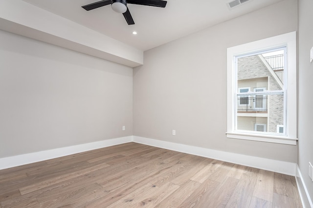 empty room featuring recessed lighting, a ceiling fan, visible vents, baseboards, and light wood-type flooring