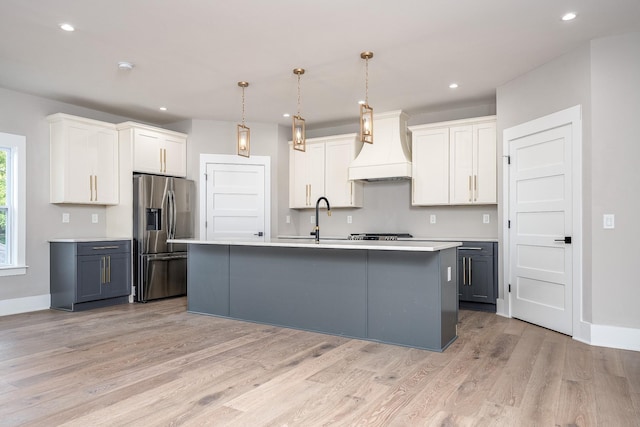 kitchen featuring pendant lighting, gray cabinets, light countertops, white cabinetry, and stainless steel fridge with ice dispenser