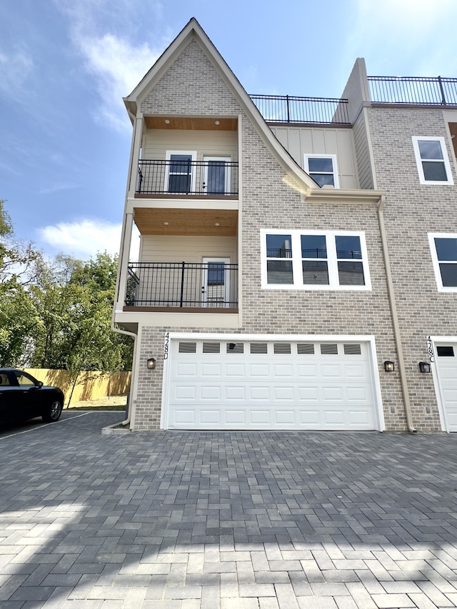 view of front of home featuring a balcony and a garage