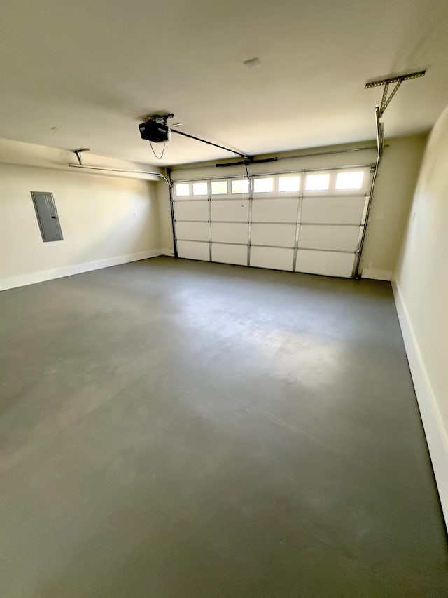 garage with baseboards and a garage door opener