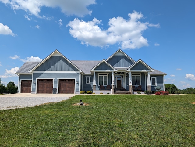 craftsman inspired home with covered porch, a garage, and a front yard