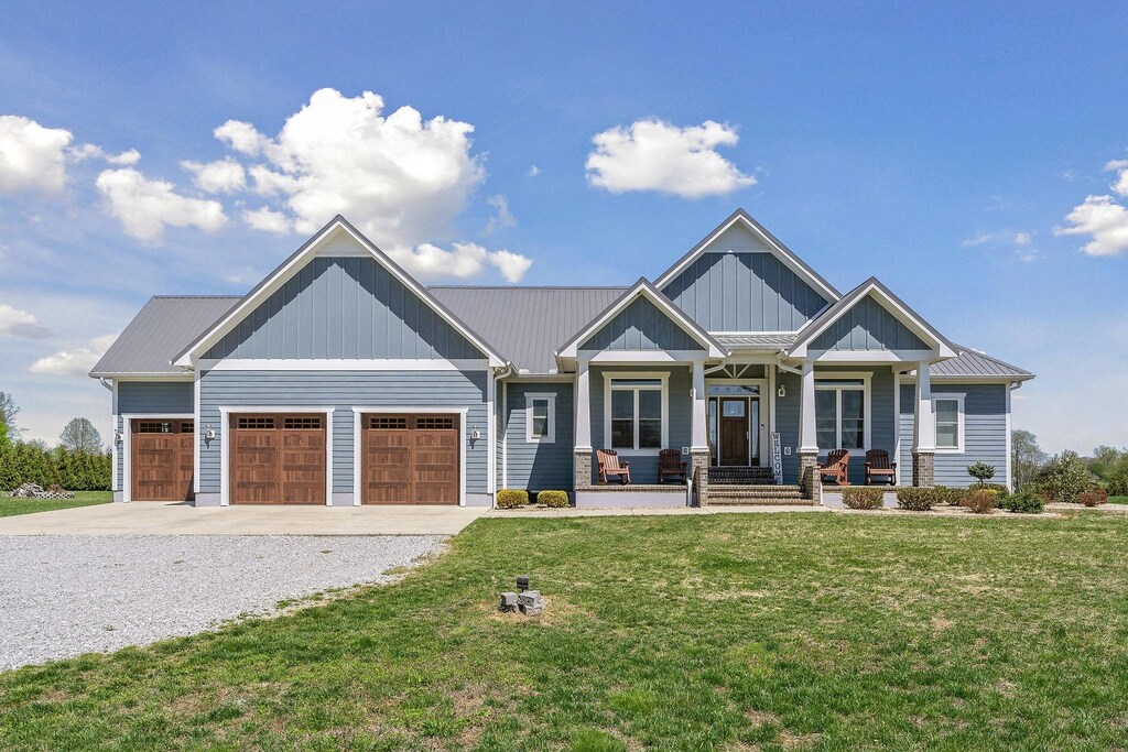 craftsman-style home featuring a porch, a garage, and a front lawn