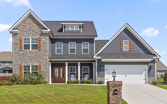 craftsman house with a porch and a front lawn