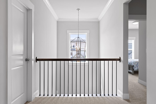 interior space featuring carpet, a chandelier, and crown molding