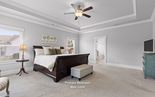 bedroom with multiple windows, a tray ceiling, ceiling fan, and light colored carpet