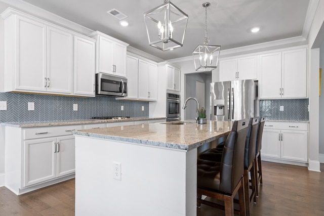 kitchen featuring white cabinets, a kitchen island with sink, stainless steel appliances, and dark hardwood / wood-style floors