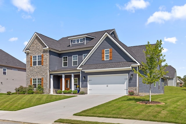 craftsman house featuring a front yard and a garage