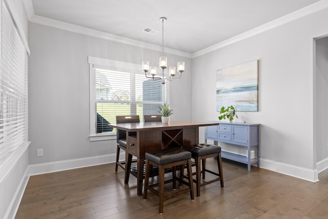 dining area with ornamental molding, a chandelier, and dark wood-type flooring