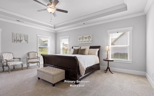 bedroom with ceiling fan, ornamental molding, a raised ceiling, and carpet flooring