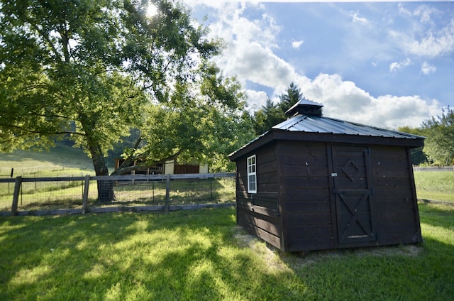 view of outbuilding featuring a yard