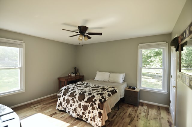 bedroom featuring hardwood / wood-style floors and ceiling fan