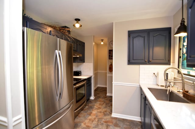 kitchen featuring tasteful backsplash, sink, stainless steel appliances, and dark tile patterned floors