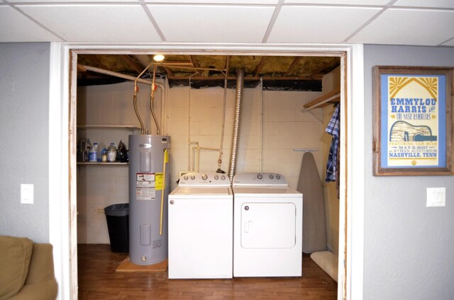 laundry area featuring electric water heater, dark wood-type flooring, and washer and dryer